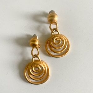 Matte gold clip on earrings with unique design.